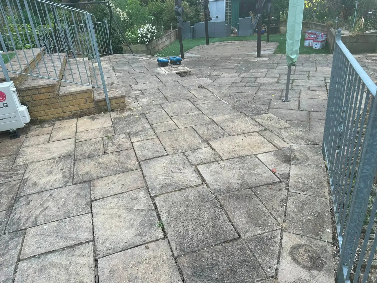 Patio before cleaning, covered in moss and dirt