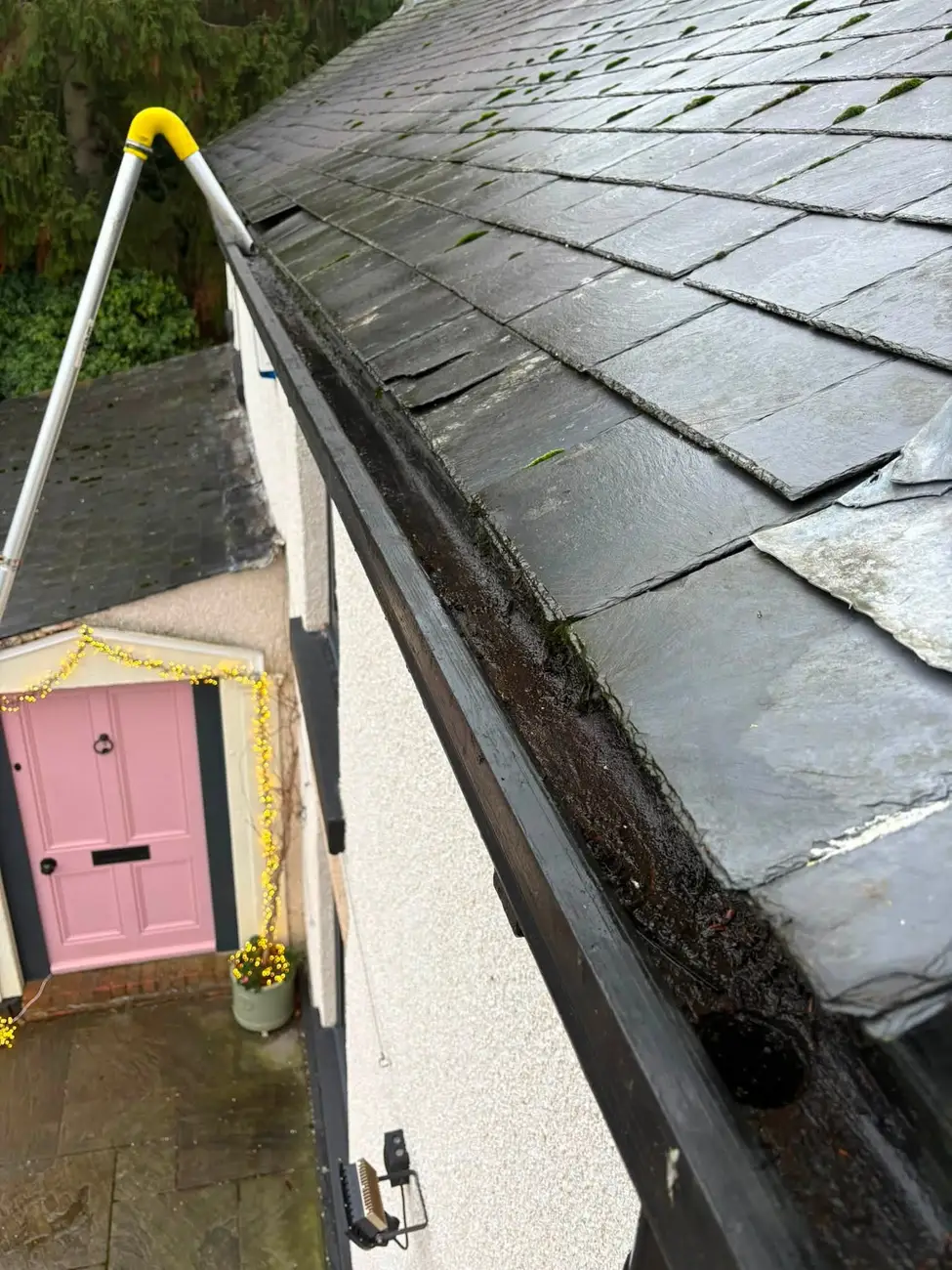 Gutter cleared of moss and debris after vacuum clearance
