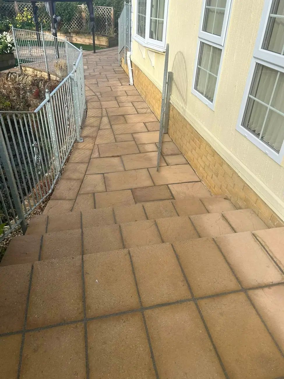Clean garden path and patio steps after pressure washing